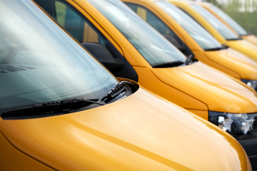 a row of yellow fleet vehicles